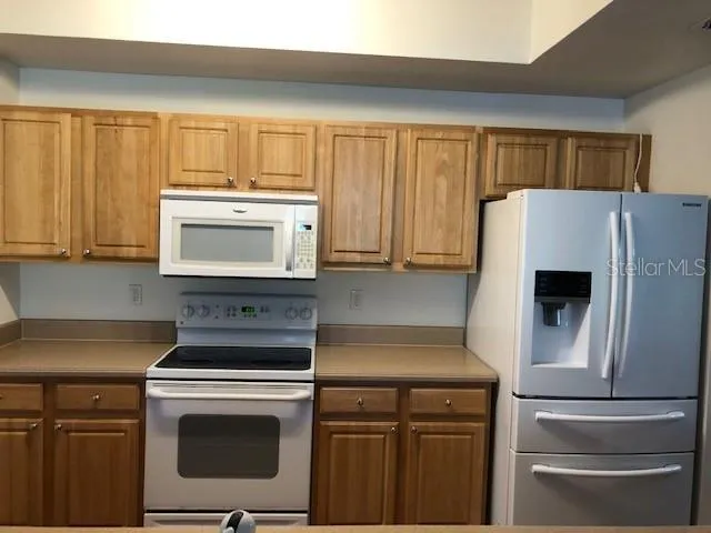 a kitchen with a stove and a refrigerator