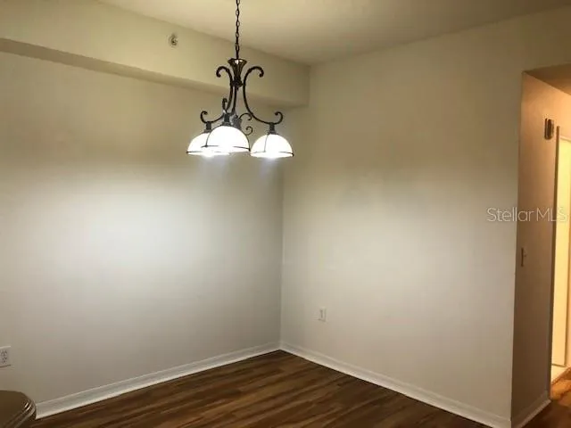 a view of a hallway with a chandelier fan