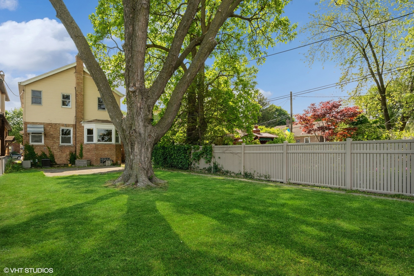 1816 North Nordica Avenue Chicago, IL 60707 - Photo 19 of 23 a view of a backyard with plants and large trees