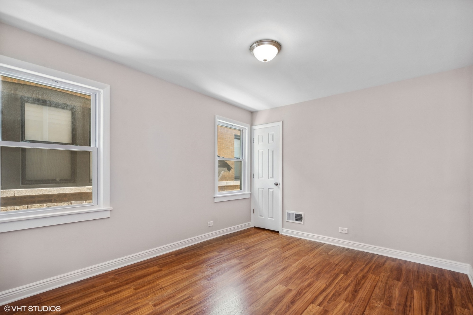 1816 North Nordica Avenue Chicago, IL 60707 - Photo 10 of 23 a view of an empty room with wooden floor and a window