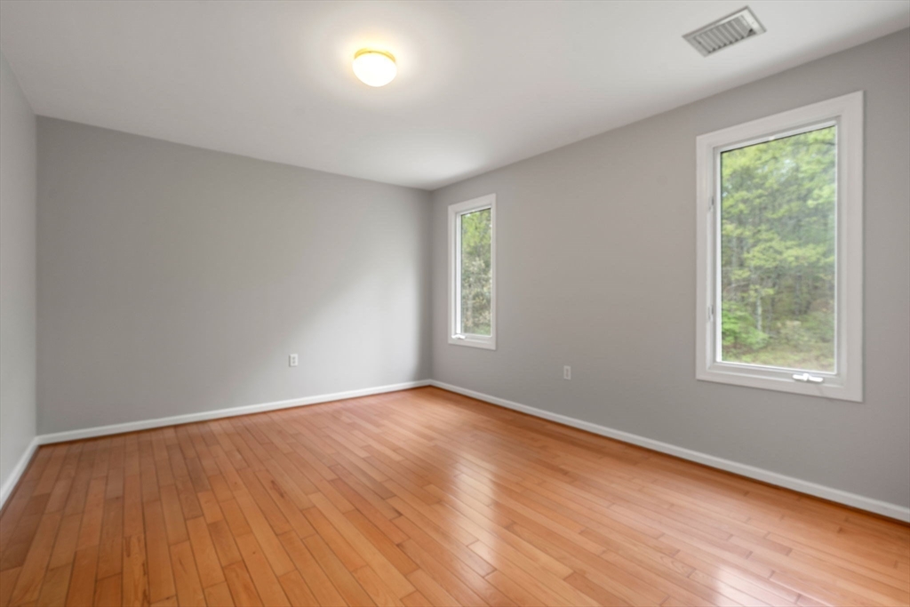 11 Black Elk Road Sharon, MA 02067 - Photo 18 of 28 an empty room with wooden floor and windows