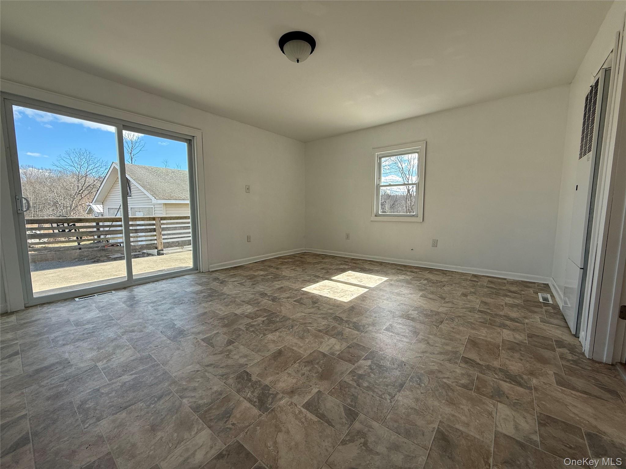 657 Eatontown Road Port Jervis, NY 12771 - Photo 2 of 14 an empty room with windows
