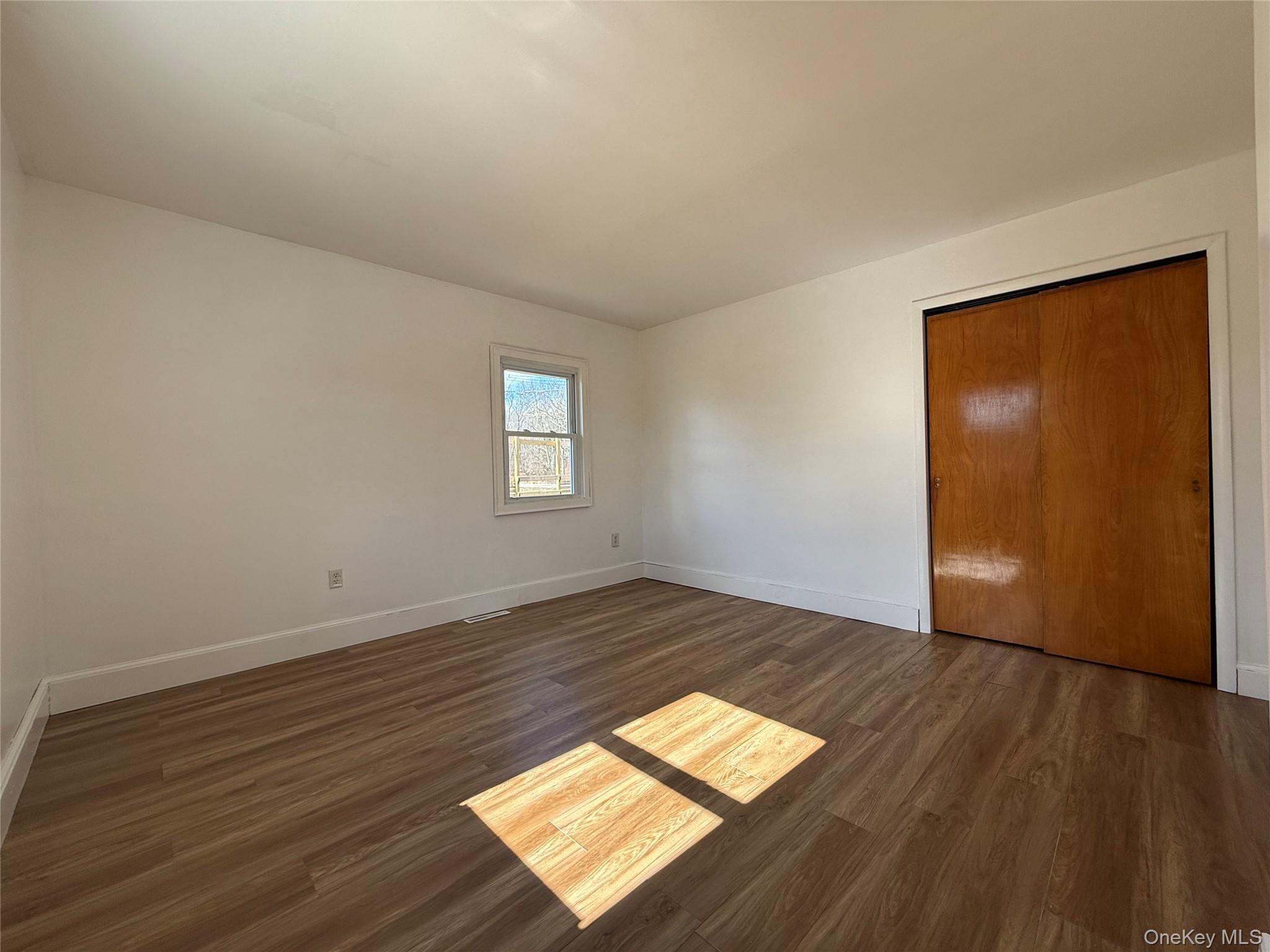 657 Eatontown Road Port Jervis, NY 12771 - Photo 5 of 14 a view of empty room with wooden floor and fan