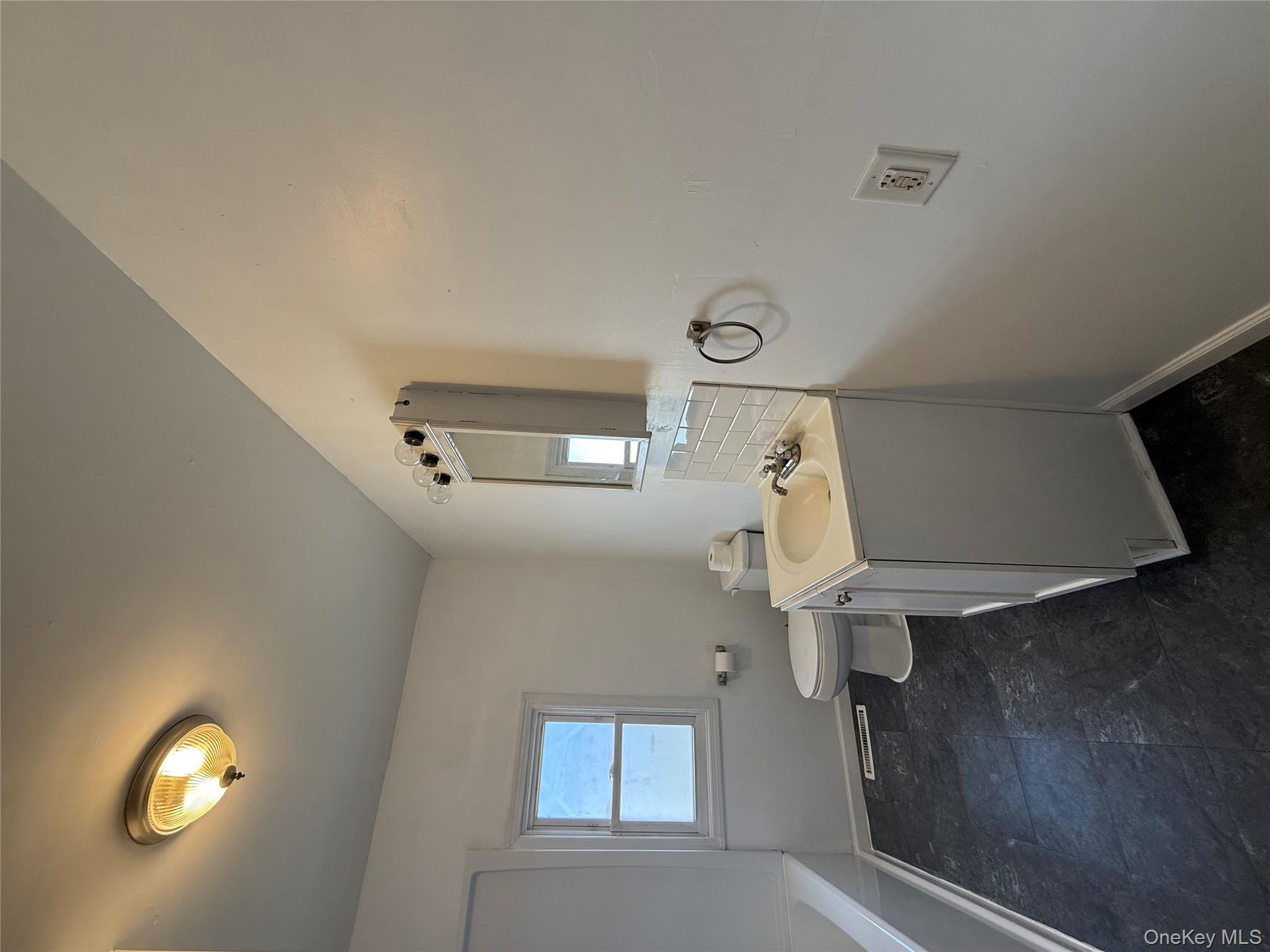 657 Eatontown Road Port Jervis, NY 12771 - Photo 7 of 14 a bathroom with a toilet sink and mirror
