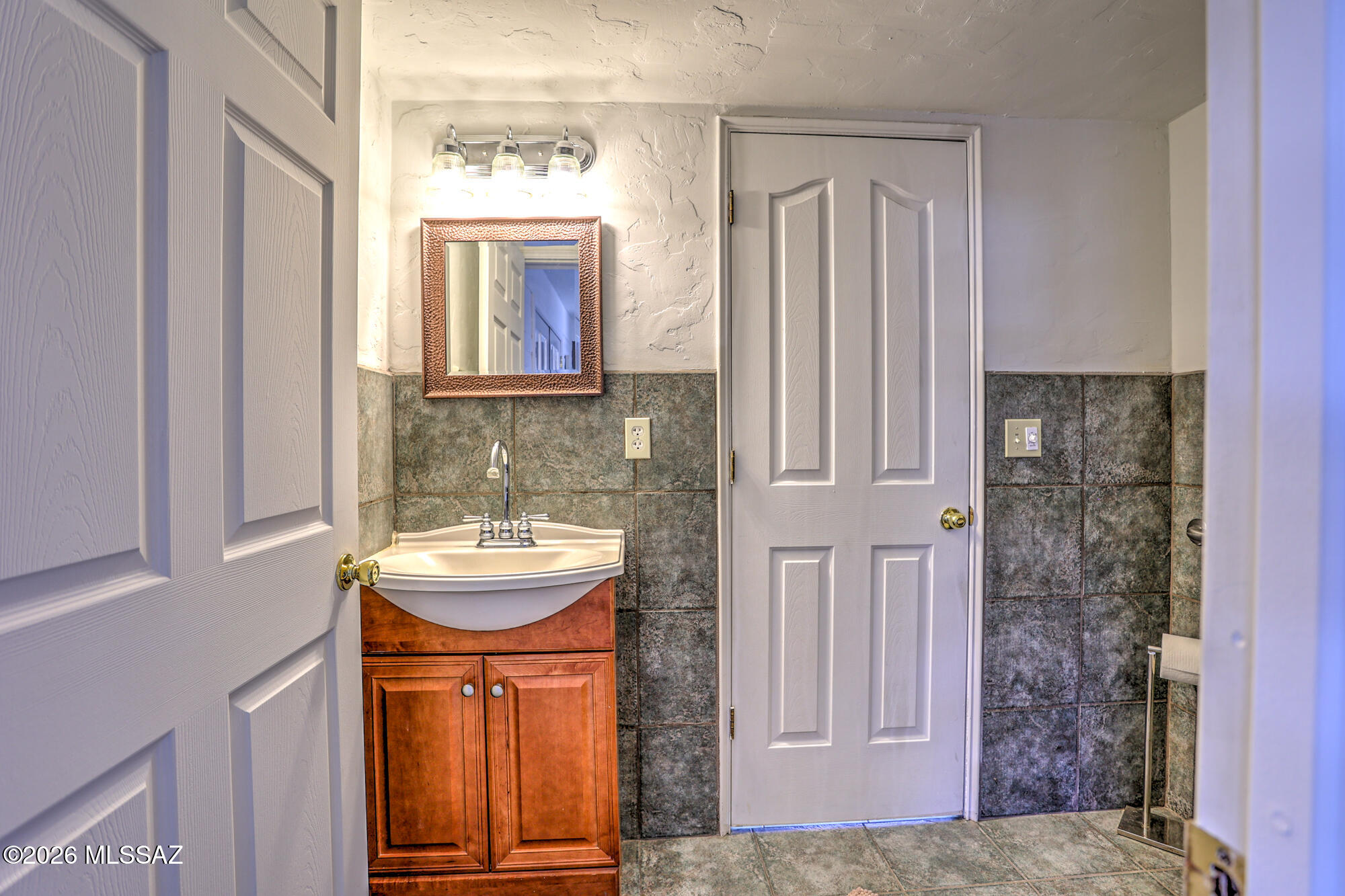 4400 West Ina Road Tucson, AZ 85741 - Photo 21 of 43 a bathroom with a sink a mirror and a shower