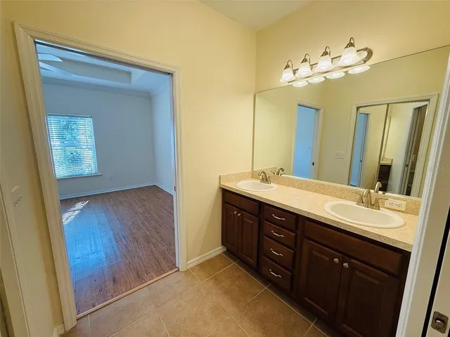a spacious bathroom with a double vanity sink and a mirror