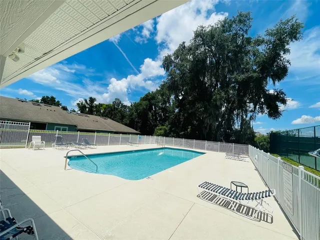 a view of a swimming pool with a patio