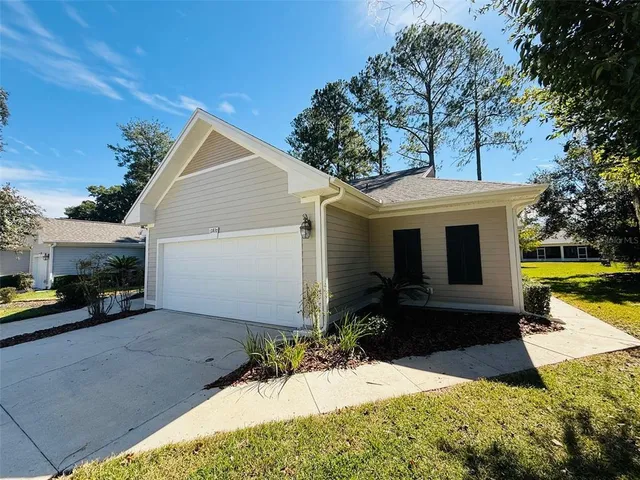 a view of a house with backyard and sitting area