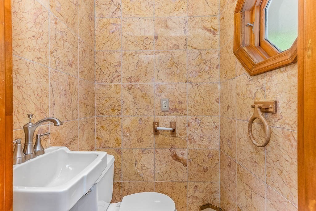 29 Berkeley Road Dedham, MA 02026 - Photo 16 of 35 a bathroom with a sink a toilet and shower