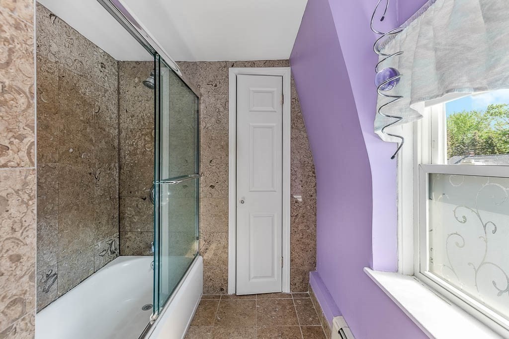 29 Berkeley Road Dedham, MA 02026 - Photo 22 of 35 a bathroom with a bathtub shower and a sink