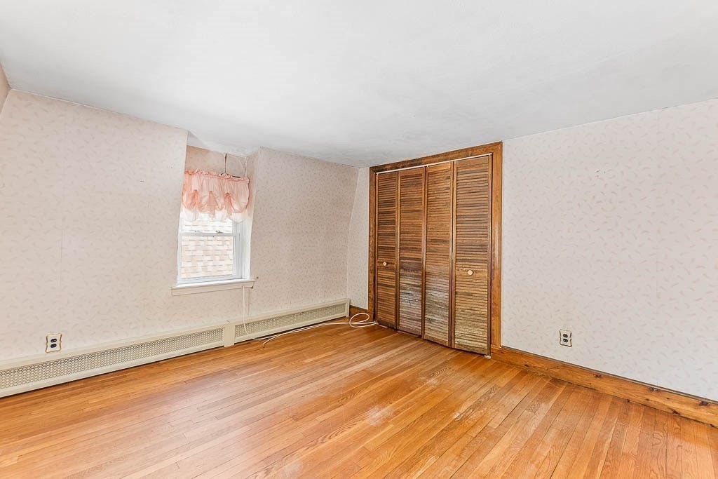 29 Berkeley Road Dedham, MA 02026 - Photo 23 of 35 an empty room with wooden floor and windows