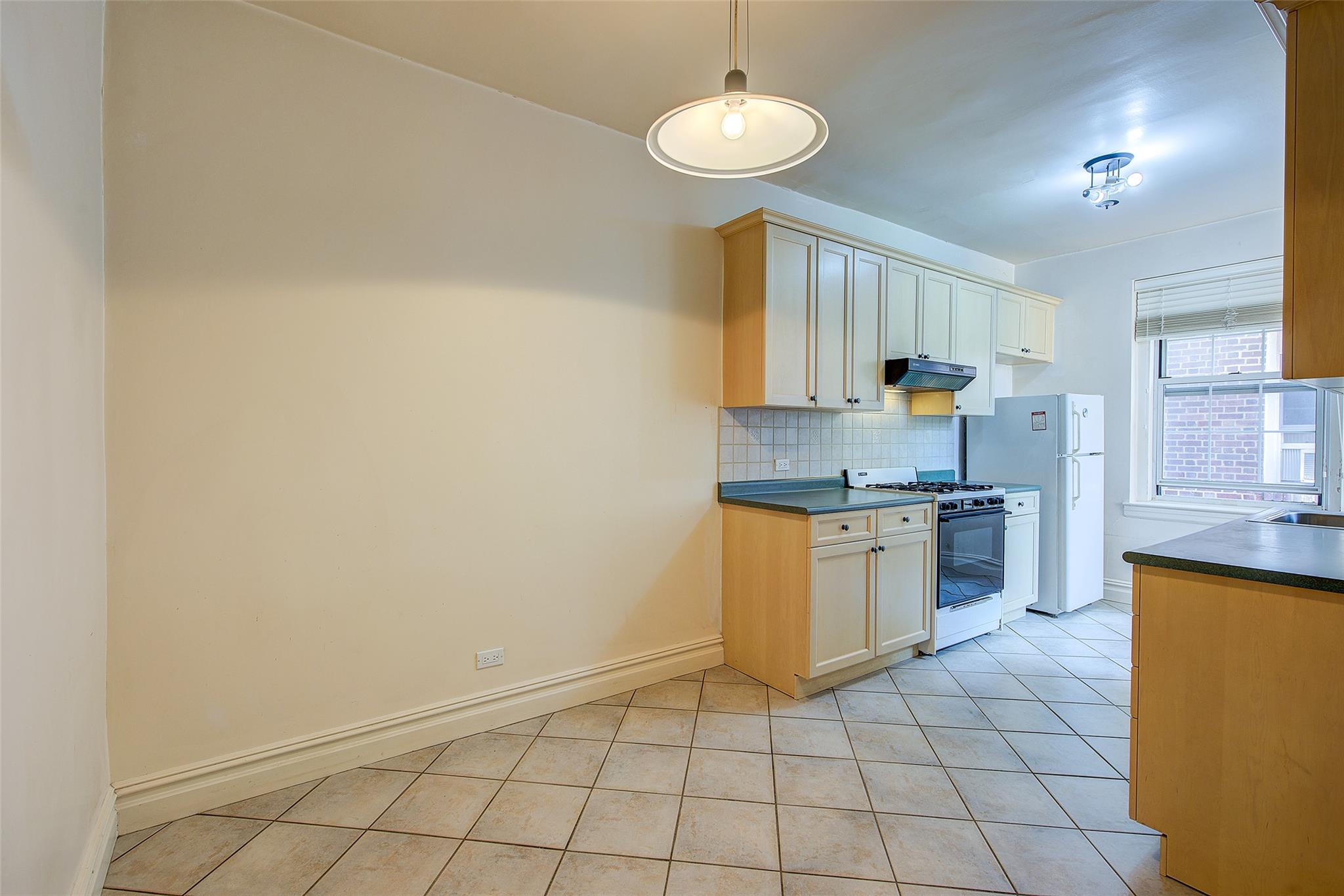 117-01 Park Lane South, Unit C5D Queens, NY 11418 - Photo 11 of 33 a kitchen with a sink a counter top space and cabinets