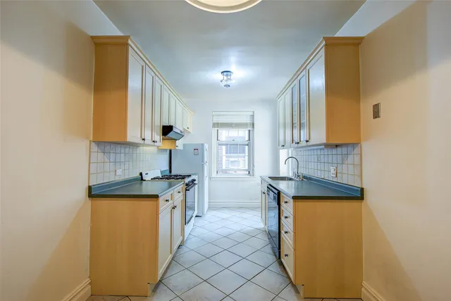 a kitchen with granite countertop a sink and a stove top oven