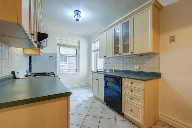 a kitchen with granite countertop a stove and a sink
