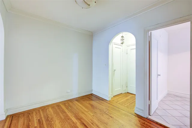 a view of a room with wooden floor and window