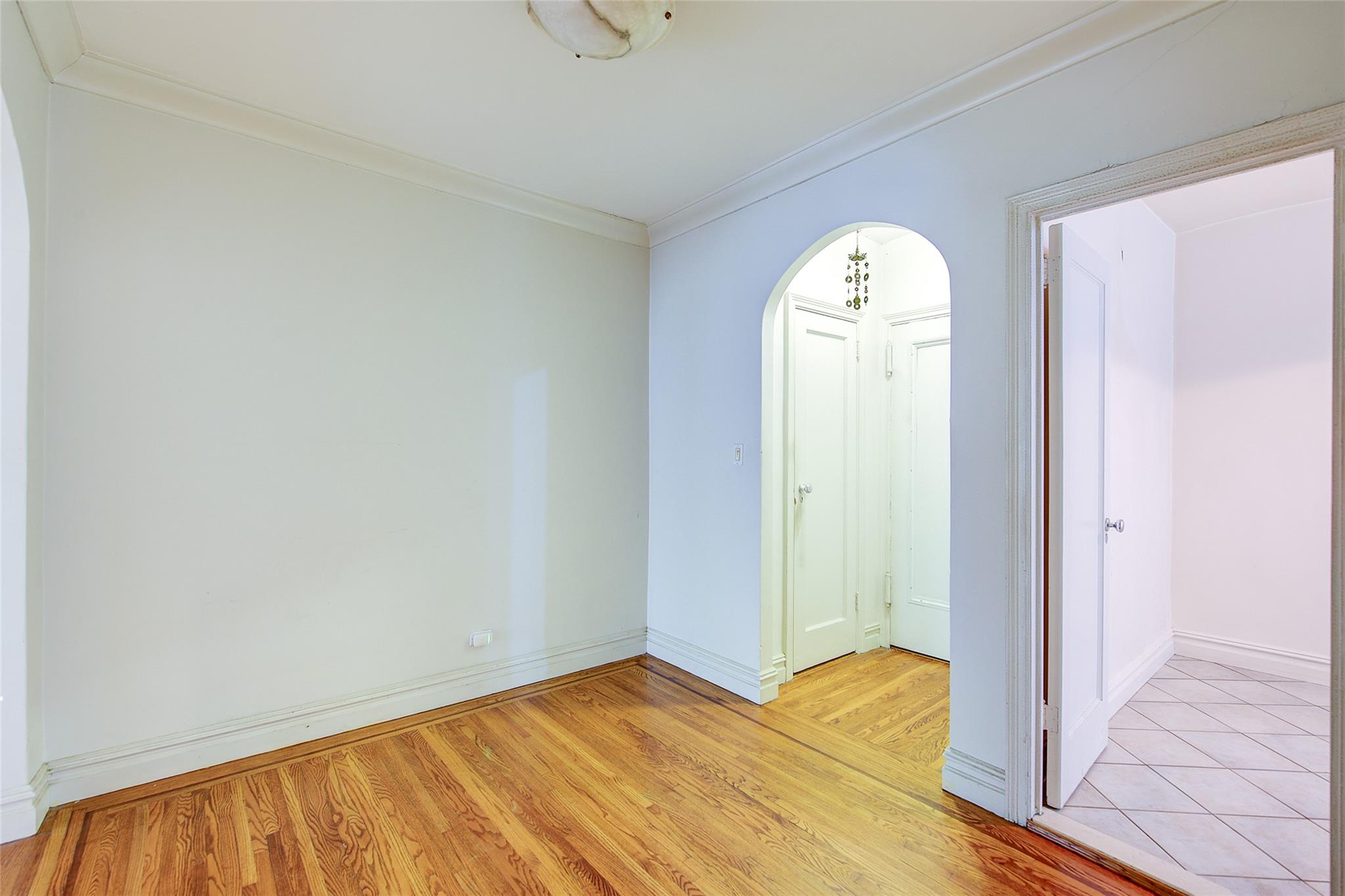 117-01 Park Lane South, Unit C5D Queens, NY 11418 - Photo 16 of 33 a view of a room with wooden floor and window