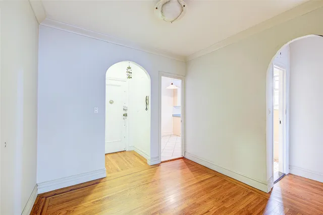 a view of a room with wooden floor and white doors