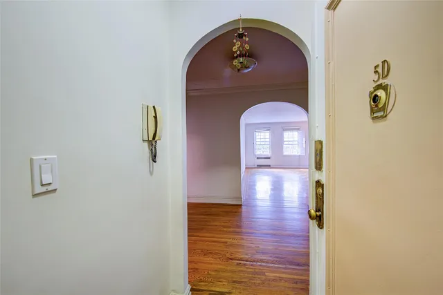 a view of a livingroom with wooden floor and a staircase