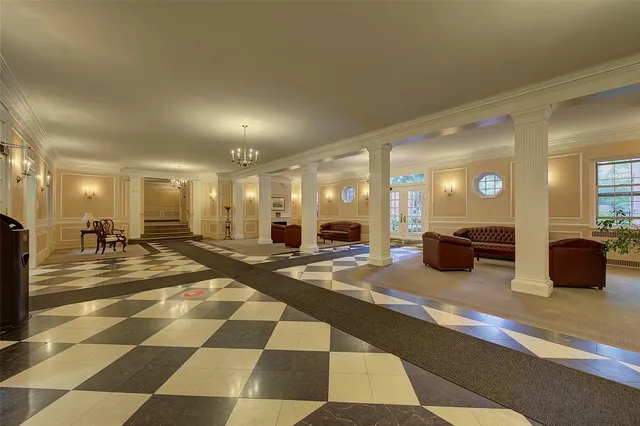 a lobby with a couch and a view of living room