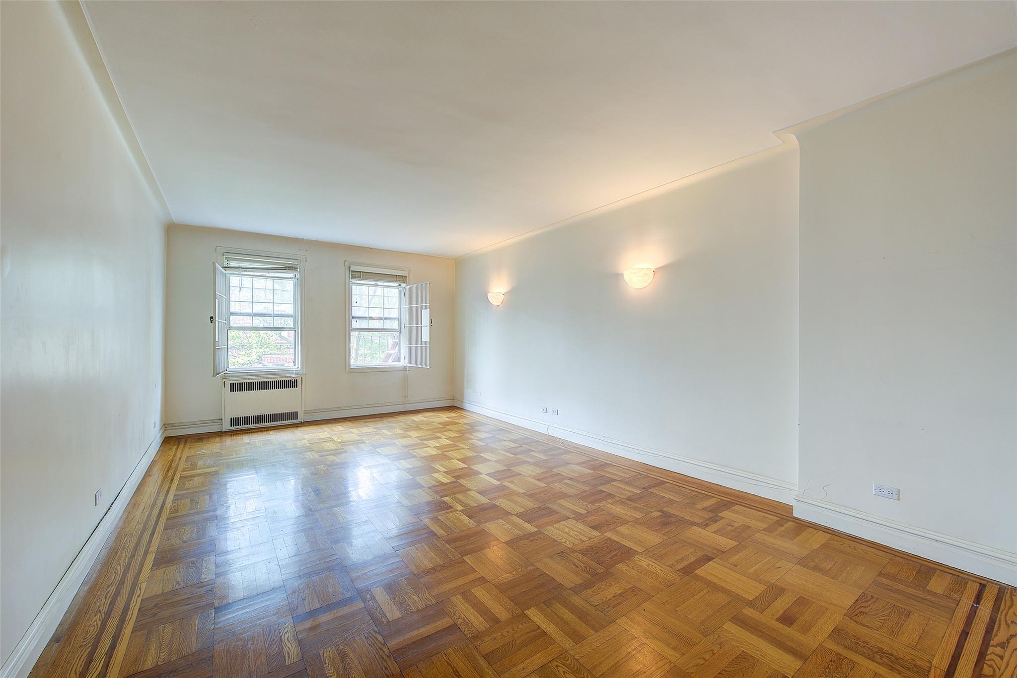 117-01 Park Lane South, Unit C5D Queens, NY 11418 - Photo 4 of 33 a view of an empty room with window and wooden floor