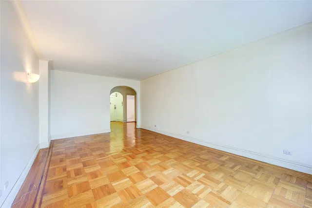 a view of a room with a wooden floor and window