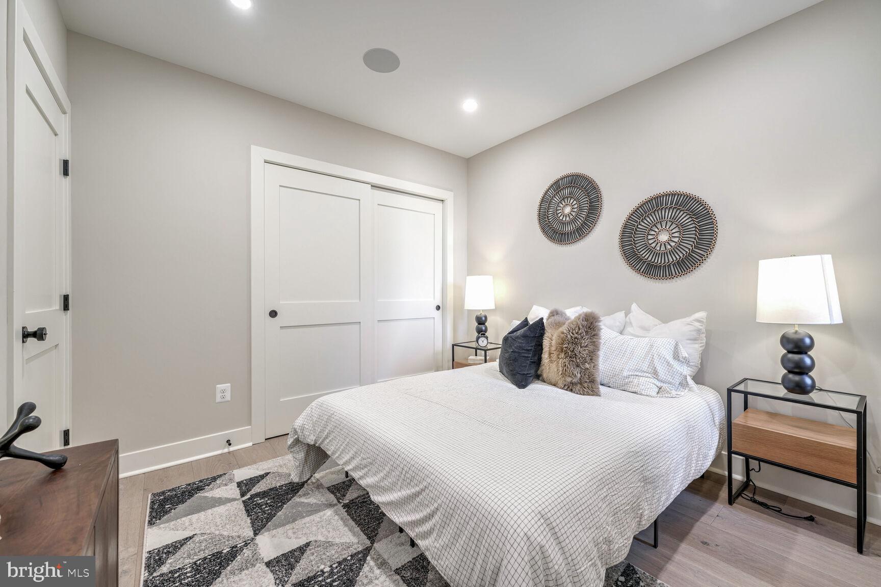 1820 19th Street Northwest, Unit 3 Washington, DC 20009 - Photo 23 of 27 a bedroom with a bed and a lamp on dresser