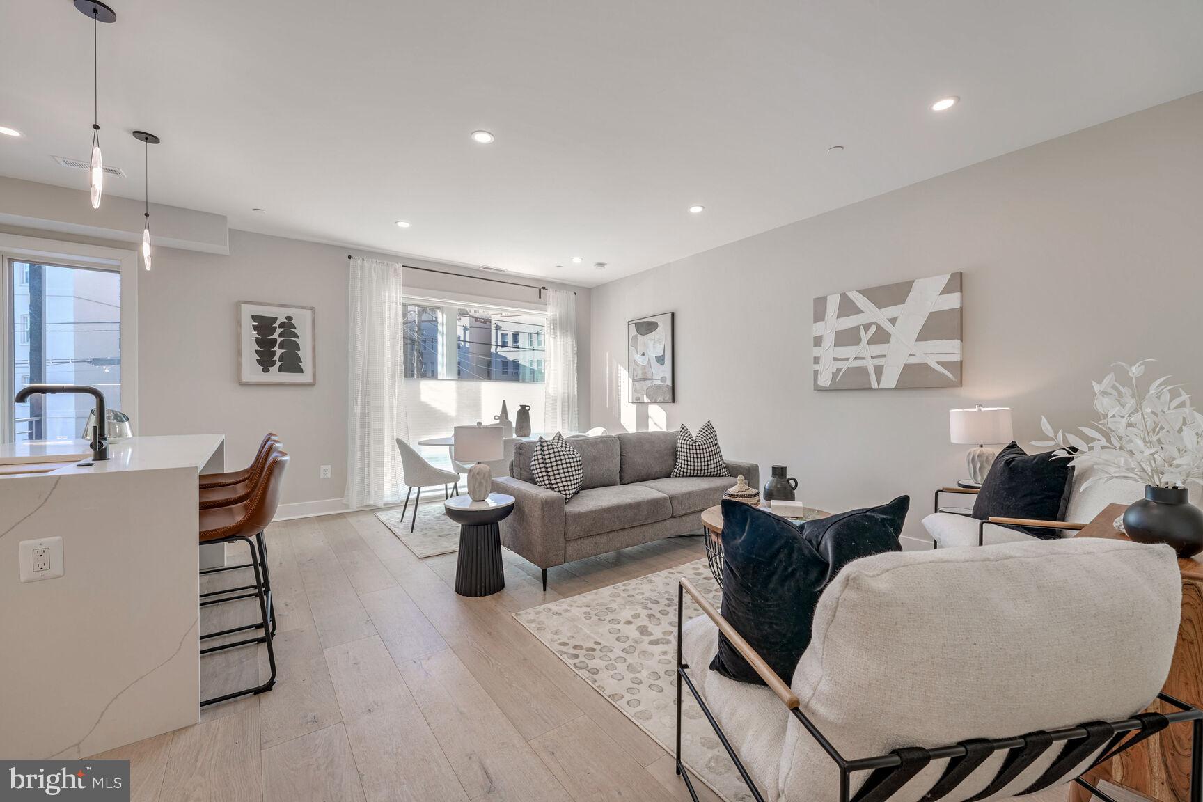 1820 19th Street Northwest, Unit 3 Washington, DC 20009 - Photo 10 of 27 a living room with furniture a wooden floor and a lamp