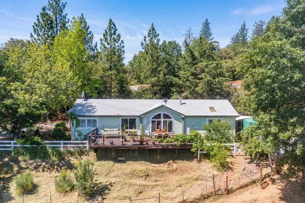 an aerial view of a house with swimming pool garden and patio