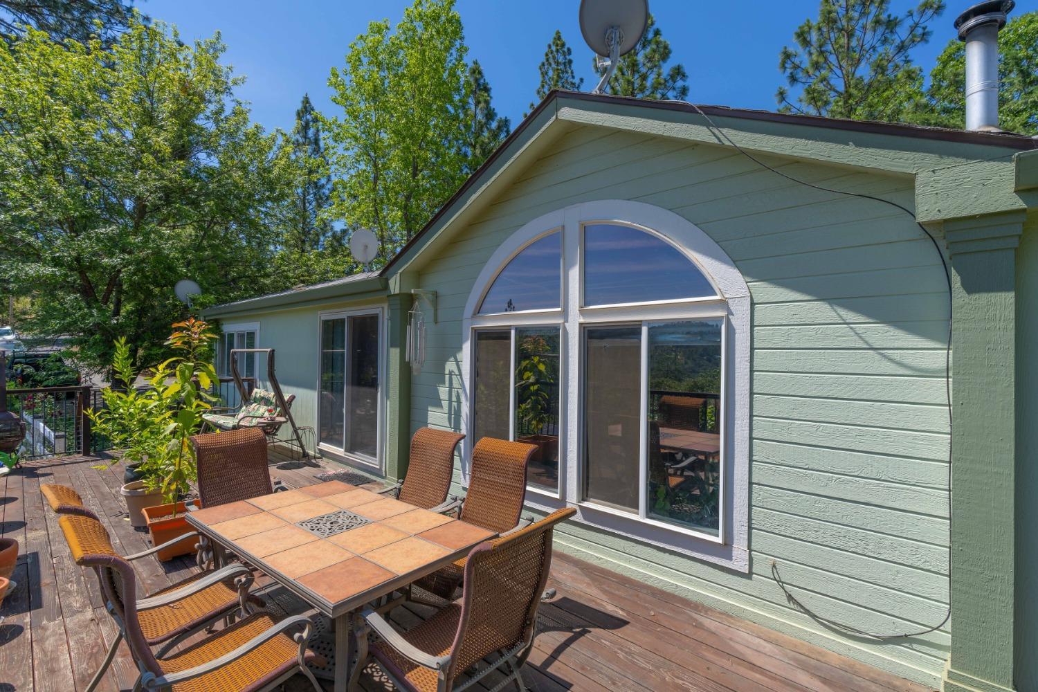 18301 Toyon Road Pine Grove, CA 95665 - Photo 2 of 15 a view of a house with a chairs and table in a patio