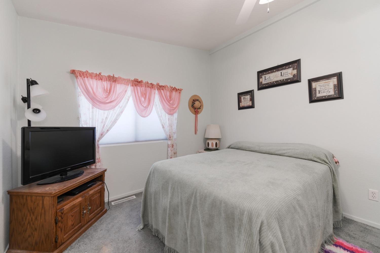 18301 Toyon Road Pine Grove, CA 95665 - Photo 9 of 15 a bedroom with a bed and a flat screen tv