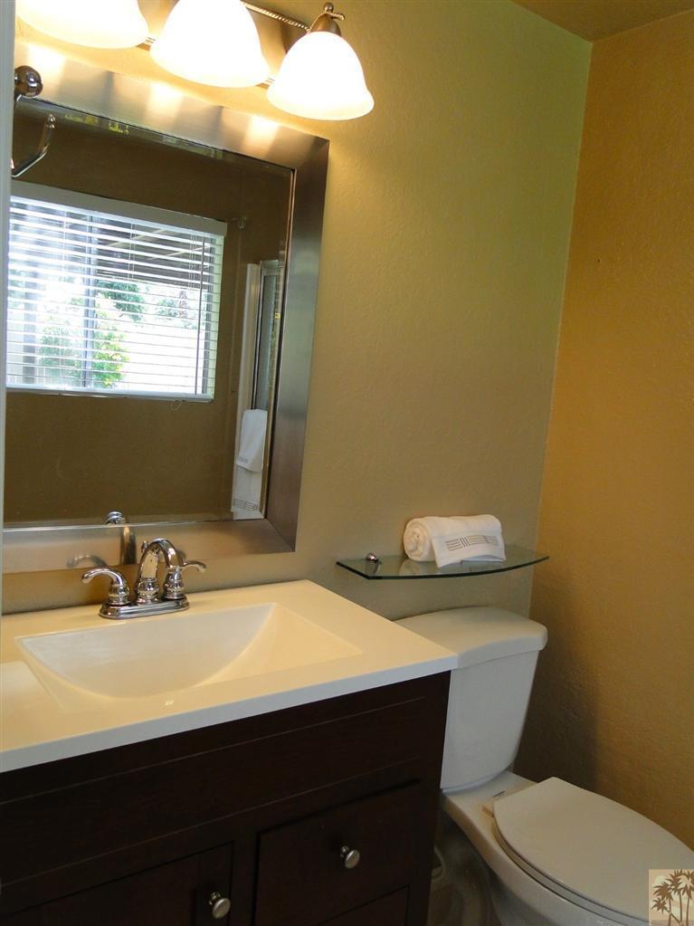 71501 Gardess Road Rancho Mirage, CA 92270 - Photo 12 of 13 a bathroom with a sink a toilet and mirror