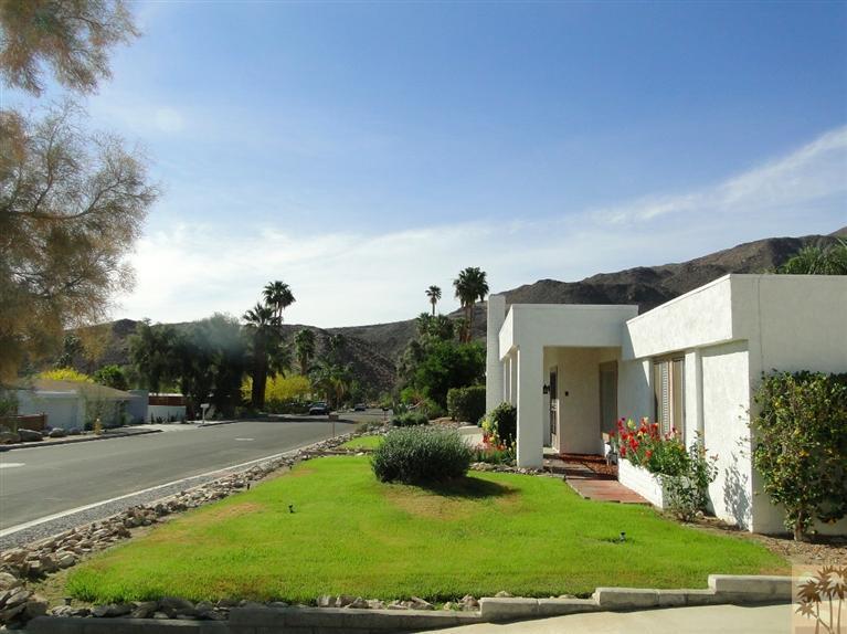 71501 Gardess Road Rancho Mirage, CA 92270 - Photo 13 of 13 a view of a white house with a yard couches and palm trees