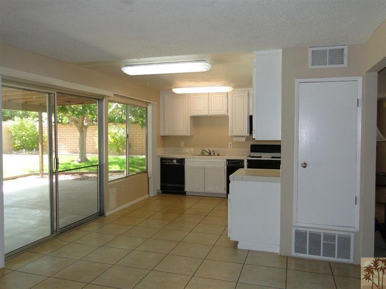 71501 Gardess Road Rancho Mirage, CA 92270 - Photo 8 of 13 a kitchen with a stove a sink and a refrigerator
