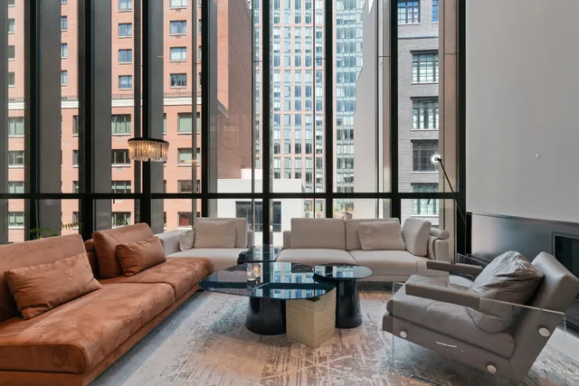 a living room with furniture and a floor to ceiling window