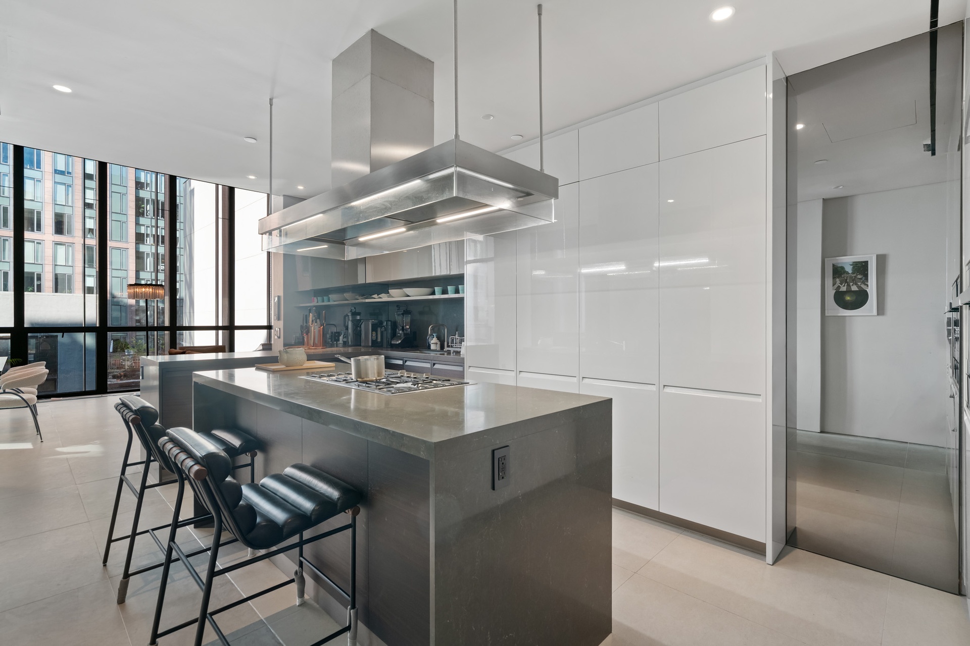 522 West 29th Street, Unit 5B Manhattan, NY 10001 - Photo 8 of 21 a kitchen with stainless steel appliances kitchen island granite countertop a sink and a refrigerator