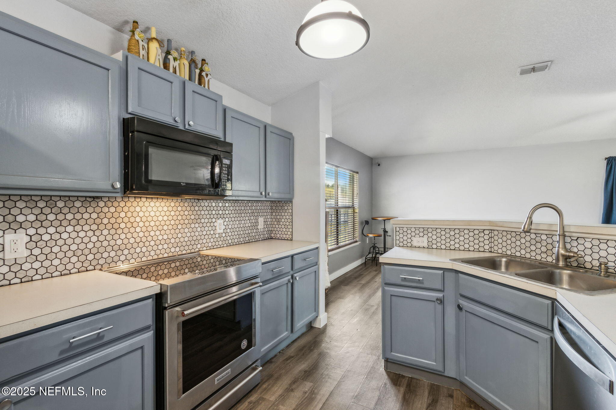 76564 Longleaf Loop Yulee, FL 32097 - Photo 19 of 54 a kitchen with a sink stove and microwave