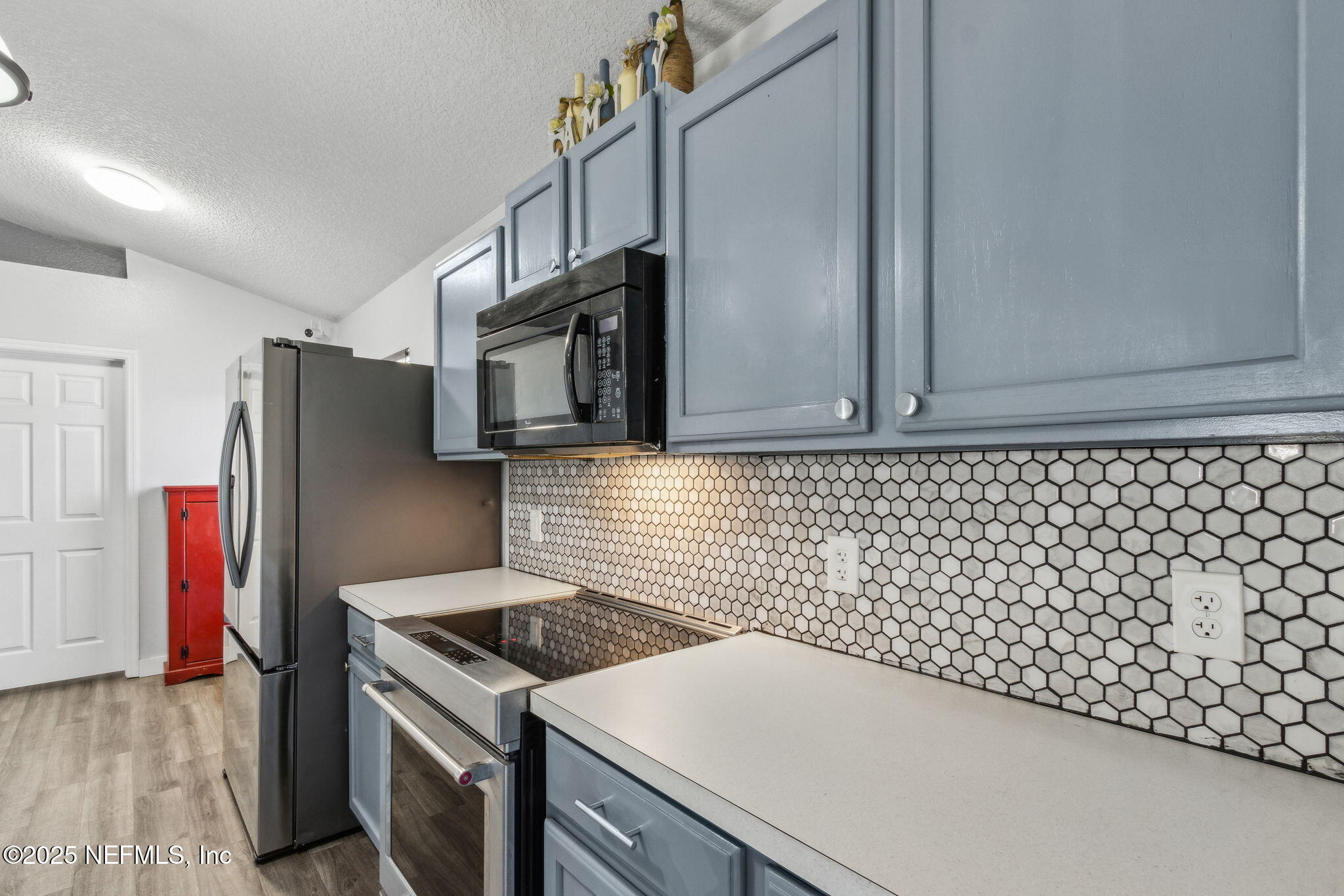 76564 Longleaf Loop Yulee, FL 32097 - Photo 21 of 54 a kitchen with granite countertop cabinets and a stove top oven