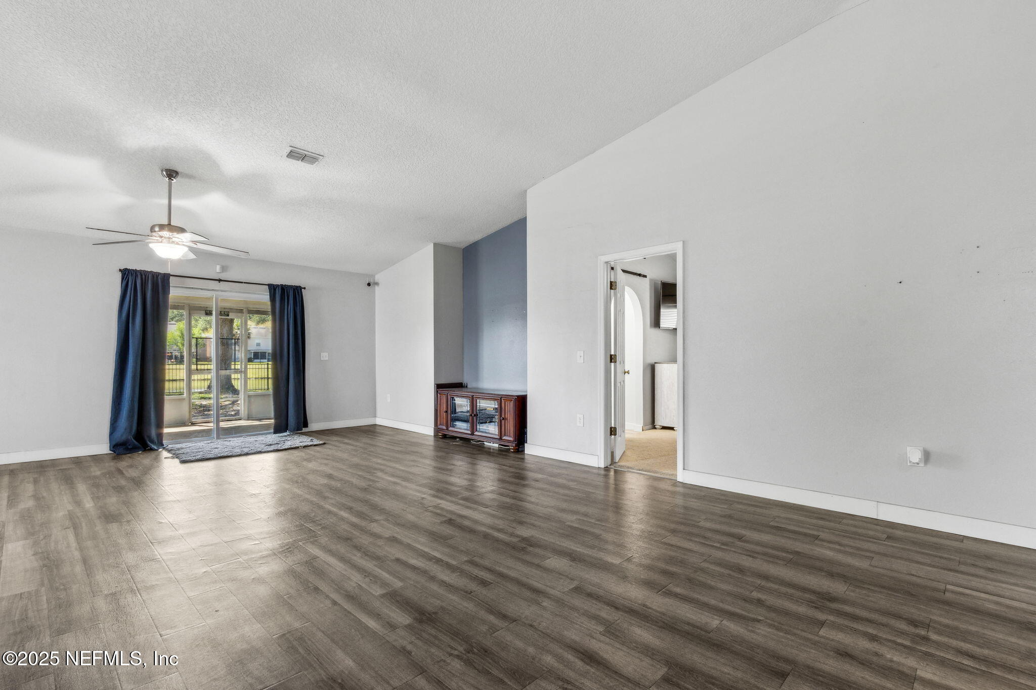 76564 Longleaf Loop Yulee, FL 32097 - Photo 23 of 54 a view of an empty room with window and wooden floor