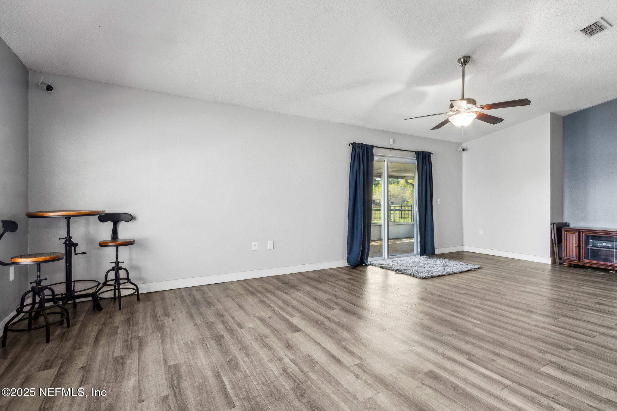 76564 Longleaf Loop Yulee, FL 32097 - Photo 29 of 54 a view of livingroom with hardwood floor and a ceiling fan