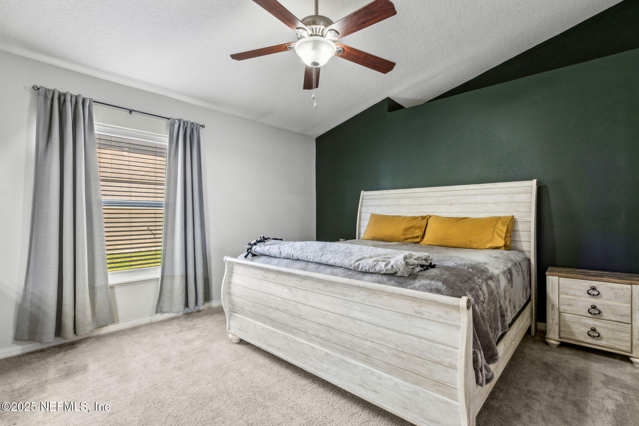 76564 Longleaf Loop Yulee, FL 32097 - Photo 30 of 54 a bedroom with a bed and a chandelier