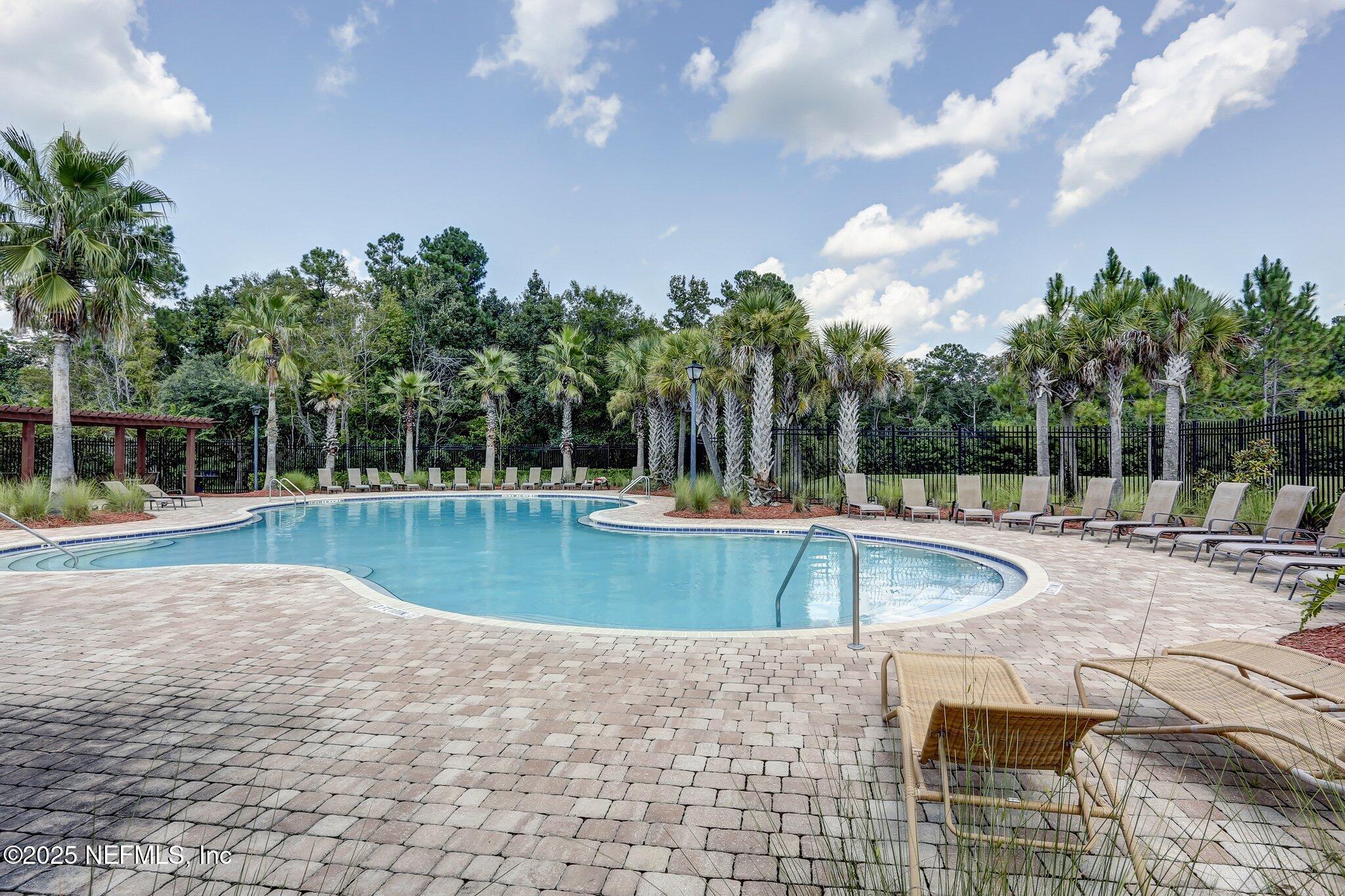 76564 Longleaf Loop Yulee, FL 32097 - Photo 3 of 54 a view of a swimming pool with a patio