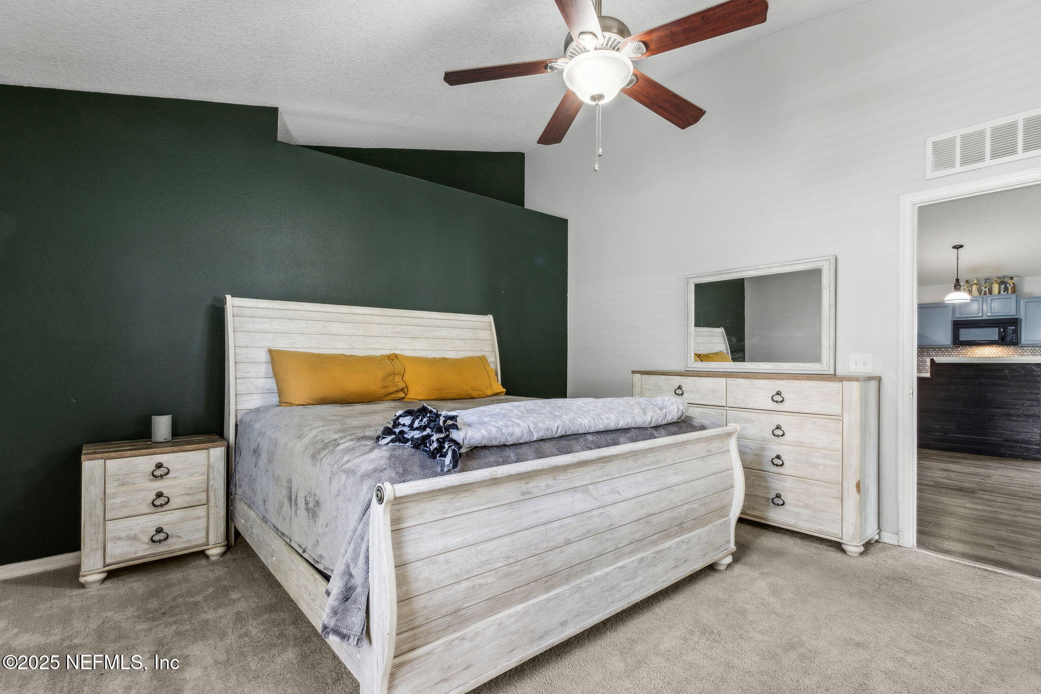 76564 Longleaf Loop Yulee, FL 32097 - Photo 32 of 54 a bedroom with a bed and a flat screen tv