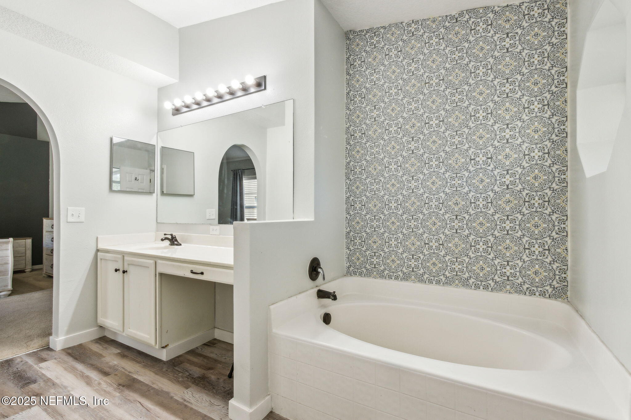 76564 Longleaf Loop Yulee, FL 32097 - Photo 34 of 54 a bathroom with a tub sink and mirror