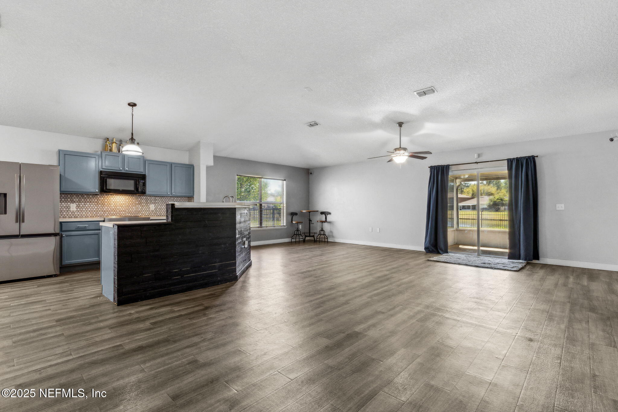 76564 Longleaf Loop Yulee, FL 32097 - Photo 4 of 54 a view of a kitchen with a sink and a stove top oven
