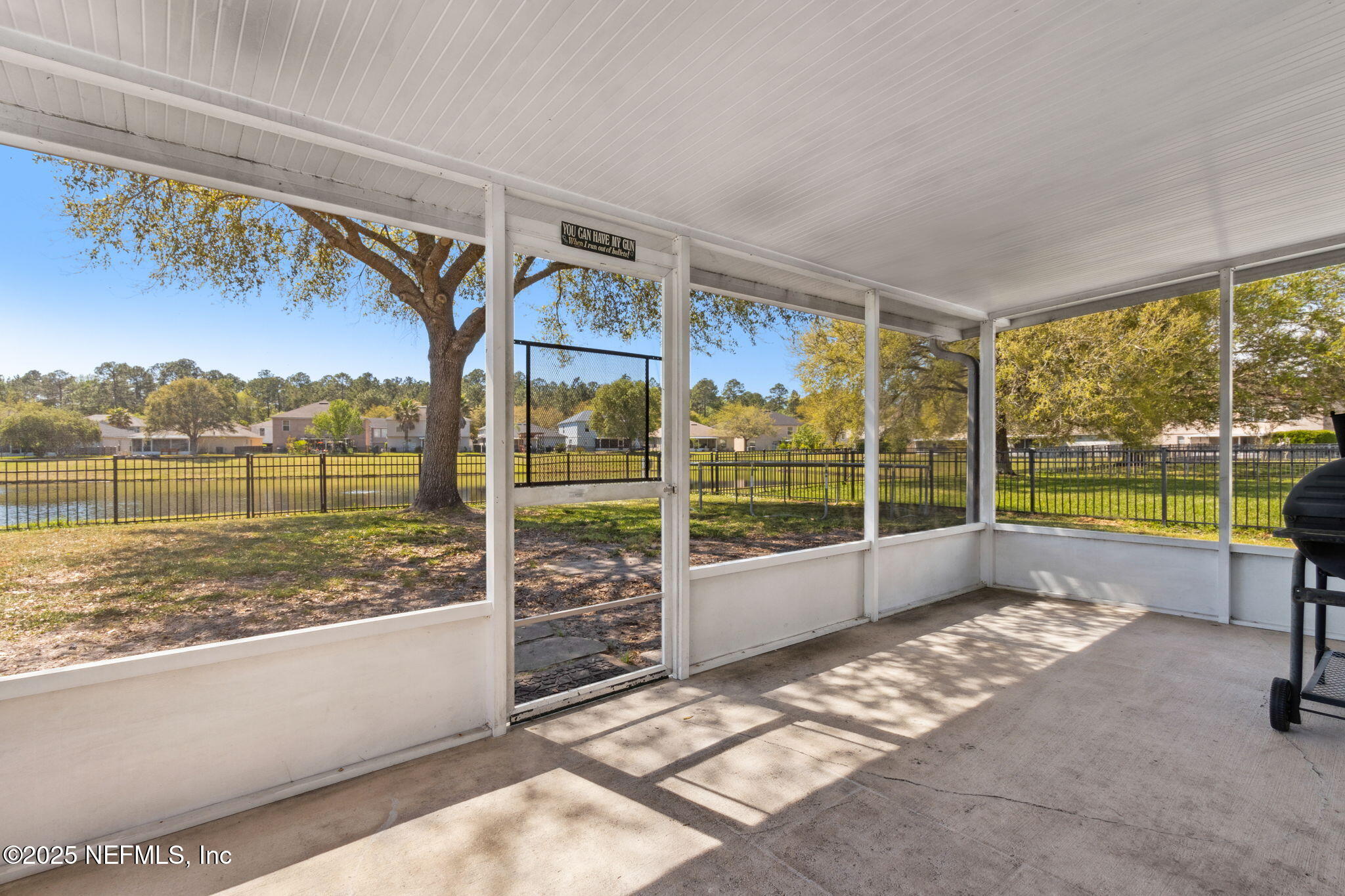 76564 Longleaf Loop Yulee, FL 32097 - Photo 47 of 54 a view of a porch with a floor to ceiling window next to a yard