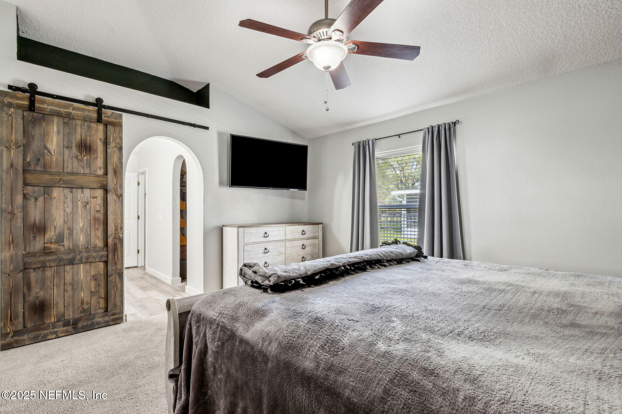 76564 Longleaf Loop Yulee, FL 32097 - Photo 5 of 54 a bedroom with a bed window and a flat screen tv