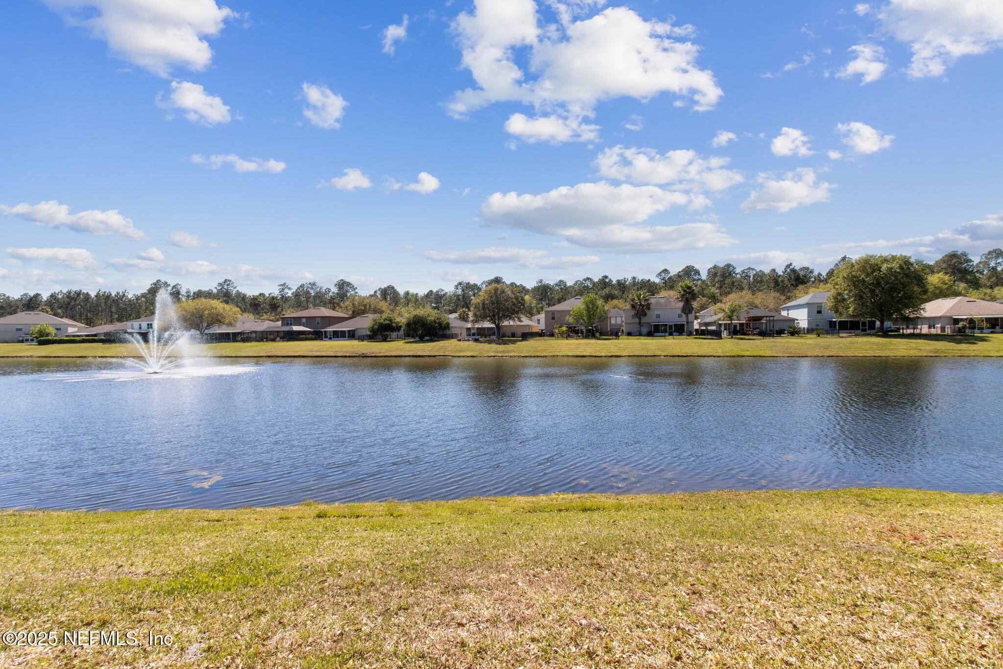76564 Longleaf Loop Yulee, FL 32097 - Photo 51 of 54 a view of a lake with houses in the background