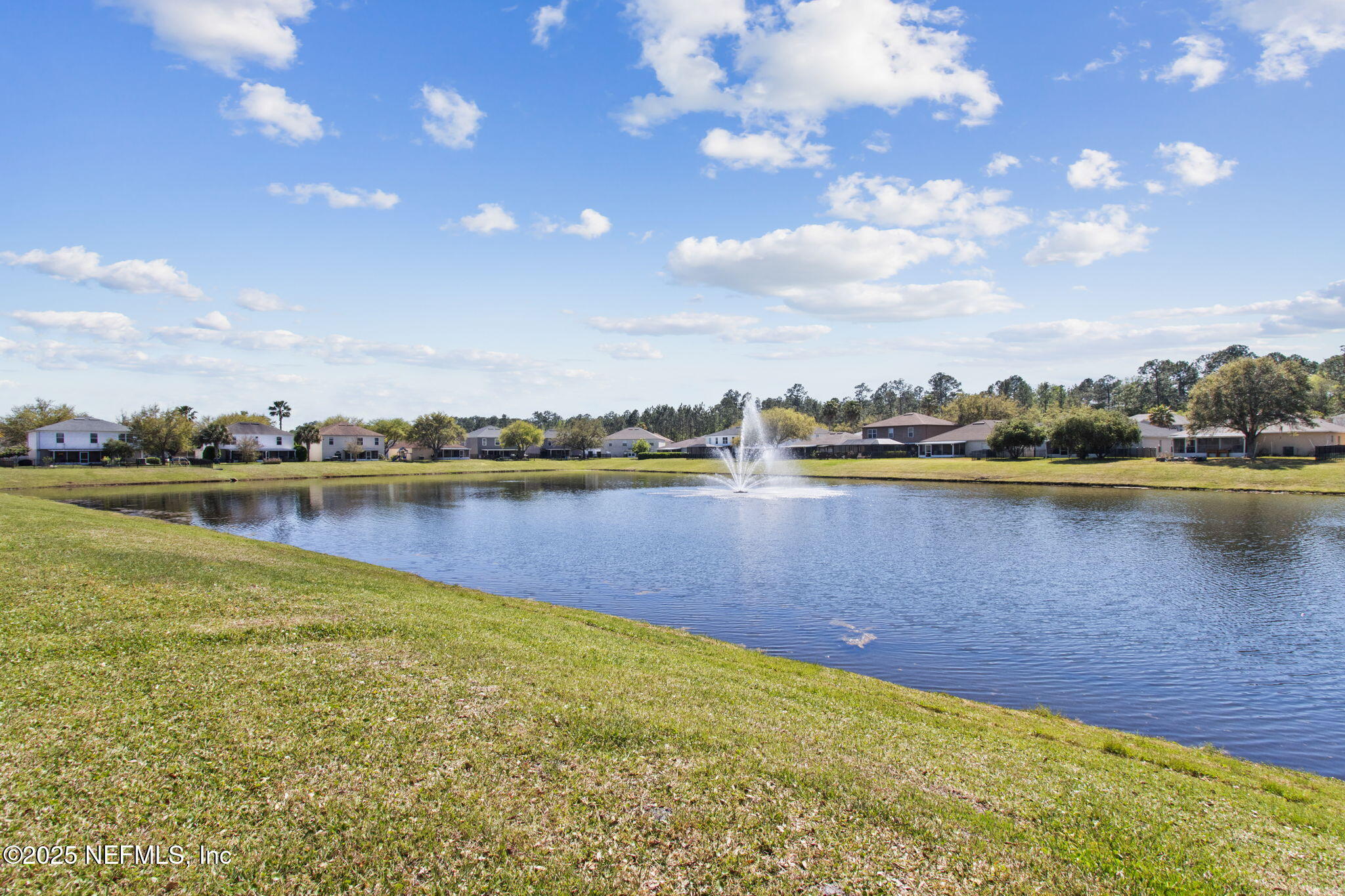 76564 Longleaf Loop Yulee, FL 32097 - Photo 52 of 54 a view of a lake with houses in the back
