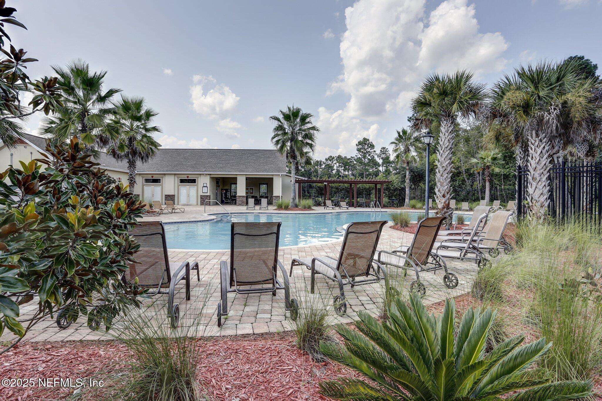76564 Longleaf Loop Yulee, FL 32097 - Photo 54 of 54 a view of a chairs and table in a patio