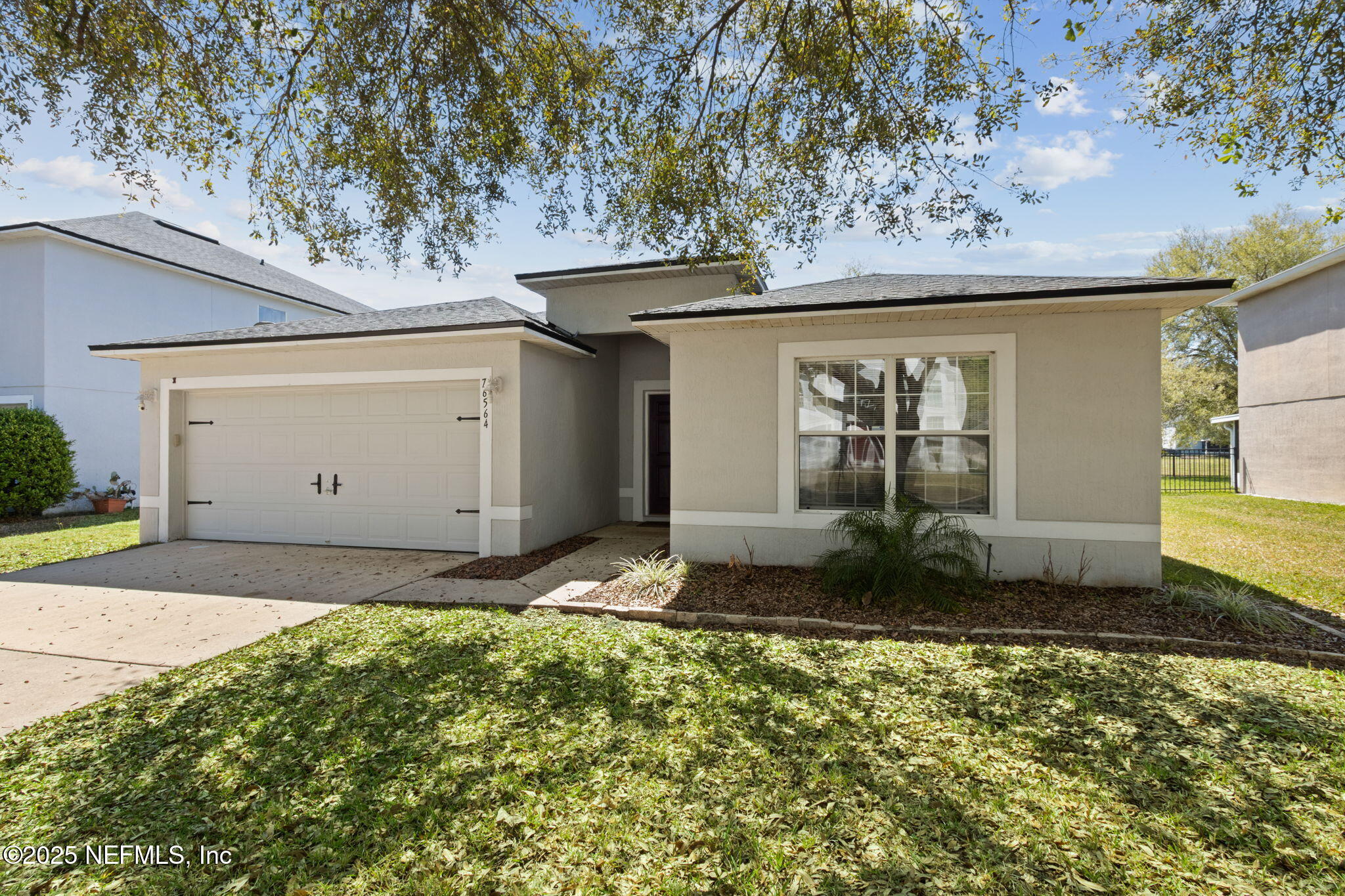 76564 Longleaf Loop Yulee, FL 32097 - Photo 6 of 54 a front view of a house with a yard